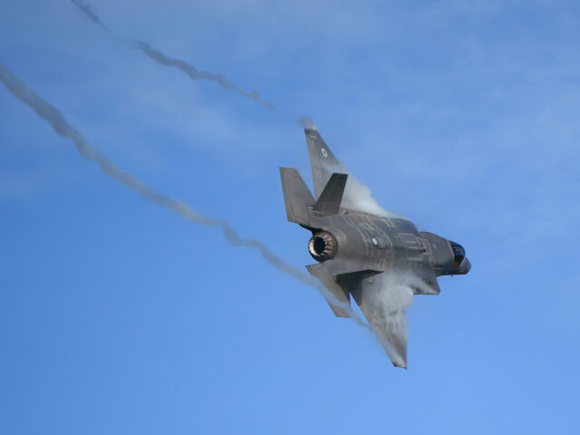 An F-35 Lightning stealth jet performs a flypast during the commissioning ceremony for 809
