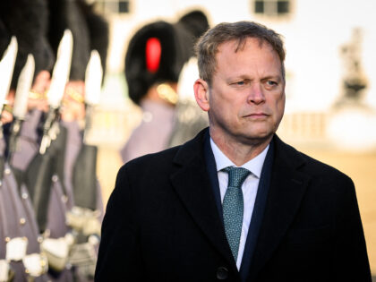 Britain's Defence Secretary Grant Shapps reacts as he accompanies India's Defence Minister