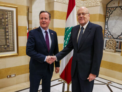 Lebanon's Prime Minister Najib Mikati (R) greets Britain's Foreign Secretary Dav