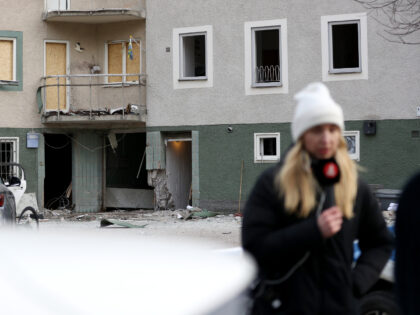 STOCKHOLM, SWEDEN - FEBRUARY 02: Members of the media stand in front a damaged block of fl
