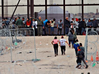 CIUDAD JUAREZ, MEXICO - FEBRUARY 06: Migrants cross the border to USA through Gate 36 and