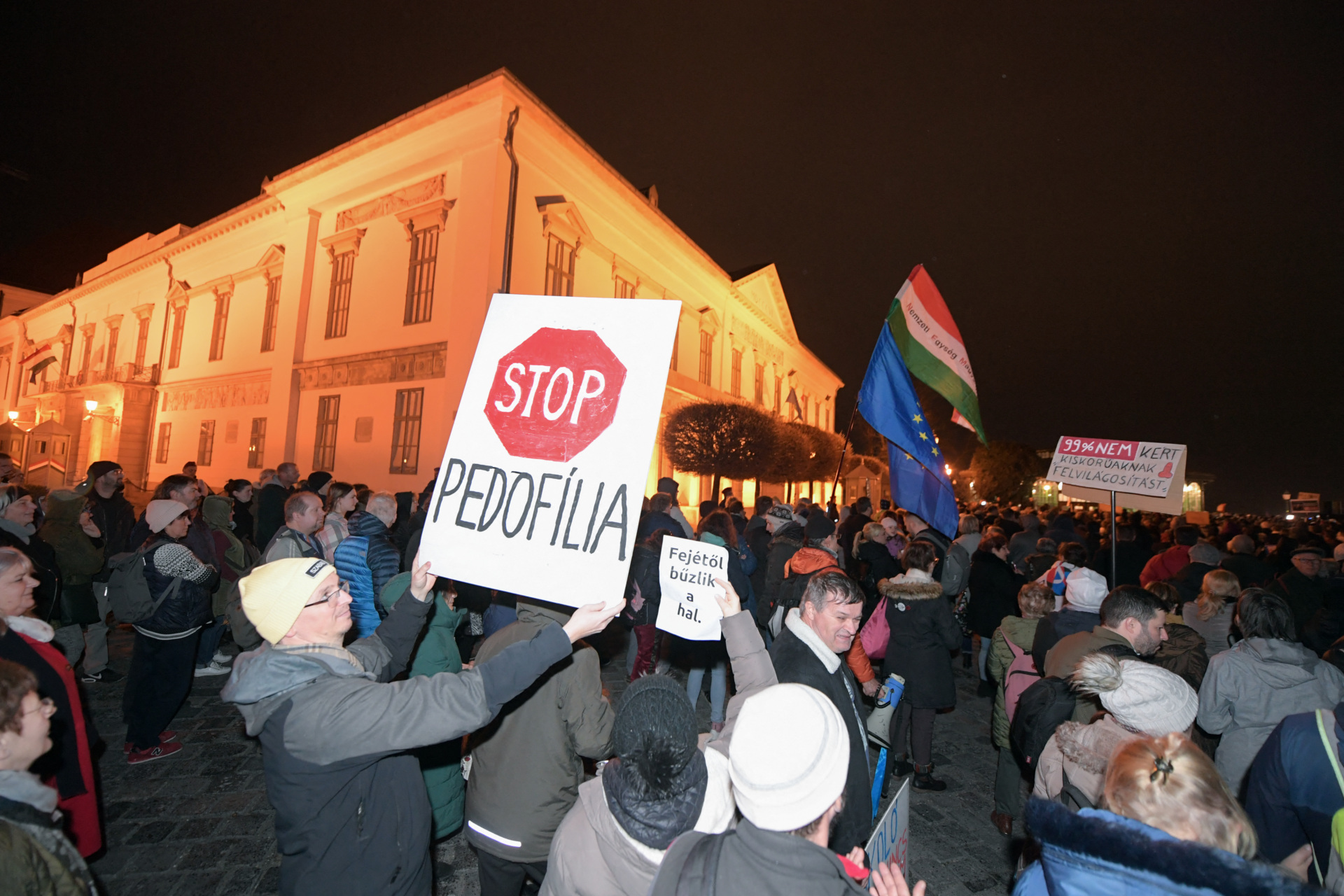 Protesters holding placards take part in a rally in Budapest in front of the Presidental offices on February 9, 2024, against Hungarian President Katalin Novak for secretly pardoning a criminal accomplice of a convicted child abuser. (Photo by Ferenc ISZA / AFP) (Photo by FERENC ISZA/AFP via Getty Images)