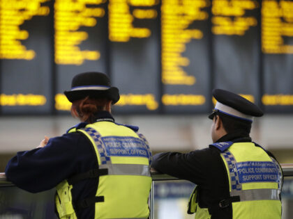 Community Support police officers stand guard in the departure hall at Kings Cross railway