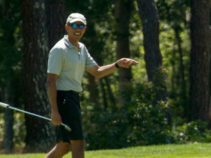US President Barack Obama reacts to his putt on the first green as he plays golf at Farm N