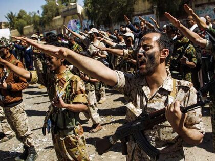Newly recruited Houthi fighters chant slogans during a gathering in the capital Sanaa to m