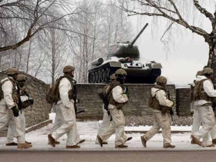 US Army soldiers passing next to the Soviet tank T-34 monument on the Narva-Joesuu - Narva