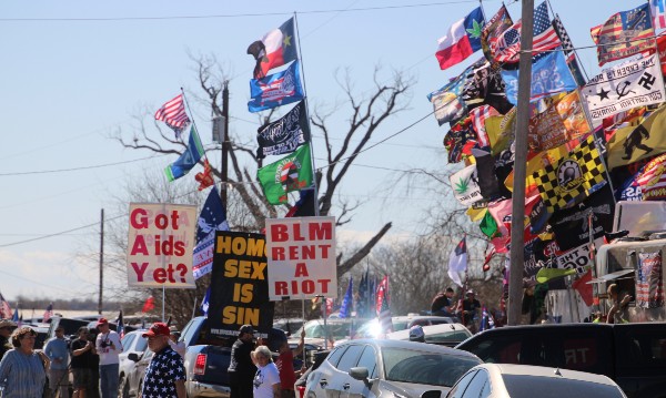 Groups outside border convoy rally display hate messages. (Randy Clark/Breitbart Texas)