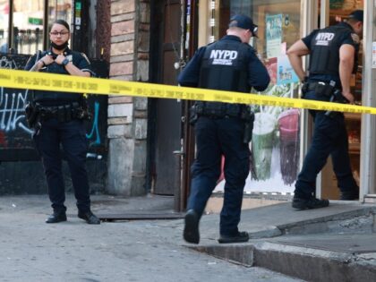 NYPD 26th Precinct and ESU Officers are seen looking for evidence at Mini Market located a