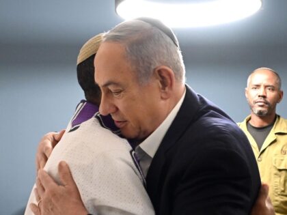 Israeli Prime Minister Benjamin Netanyahu embraces a relative of Staff Sgt. Neria Baleta,