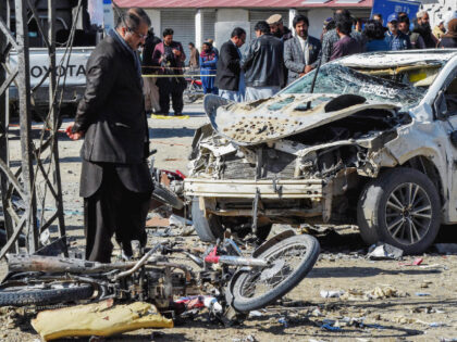 TOPSHOT - A security personnel inspects the site of a bomb blast outside the office of an