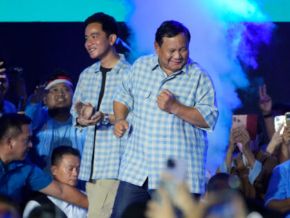 Presidential candidate Prabowo Subianto, right, shows a dance move as his running mate Gib