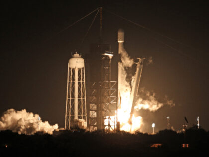 TOPSHOT - A SpaceX Falcon 9 rocket lifts off from launch pad LC-39A at the Kennedy Space C