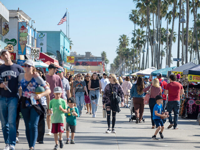 LOS ANGELES, CALIFORNIA - FEBRUARY 06: People walk along the Venice Beach boardwalk on Feb