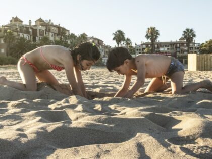 children playing in sand at beach