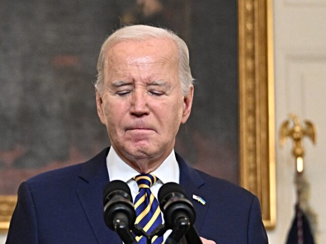 US President Joe Biden pauses while speaking in the State Dining Room of the White House o