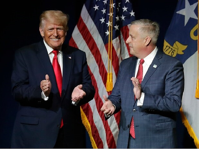 Former President Donald Trump, left, is welcomed by Michael Whatley, Chairman of the N.C. GOP, before he speaks at the North Carolina Republican Convention Saturday, June 5, 2021, in Greenville, N.C. (AP Photo/Chris Seward)