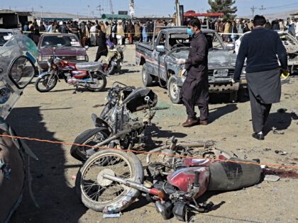 Officials collect evidences at the site of a bomb blast outside the office of an independe