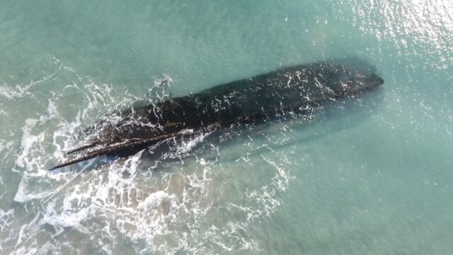 An aerial view of an old shipwreck on the shore of Cape Ray, Newfoundland and Labrador, Ca