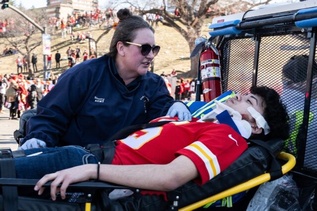 An injured person is aided after the shooting at the Kansas City Chiefs' Super Bowl victor