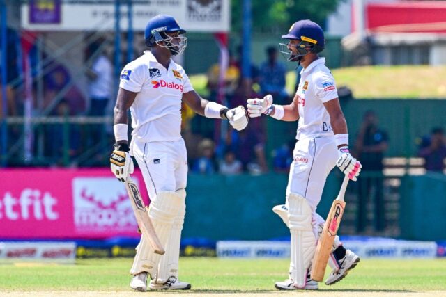 Angelo Mathews (left) brought up his 41st half-century in Test cricket with a single, whi