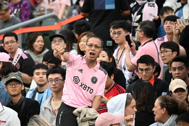 Angry fans in Hong Kong boo and give thumbs-down gestures after Lionel Messi failed to tak