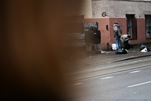 Erica Hetfeld looks on as people use fentanyl openly in the street in downtown Portland, O