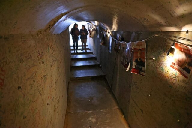 Portraits of hostages in a reconstruction of a Gaza tunnel in Tel Aviv's "Hostages Square"