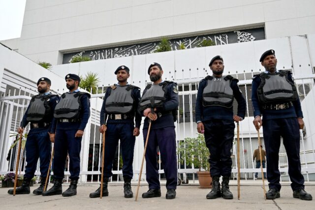 Security personnel stand guard outside Pakistan's National Assembly before lawmakers bega