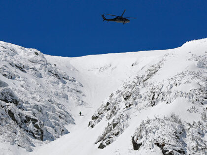In this Monday, April 23, 2018 photo a National Guard helicopter flies over Mount Washingt