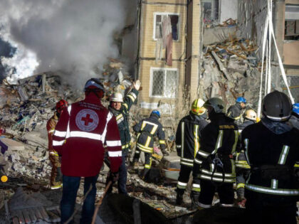 In this photo provided by the Ukrainian Emergency Service, emergency workers clear the rub
