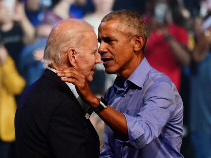 President Joe Biden (L) and former U.S. President Barack Obama (R) embrace on stage during