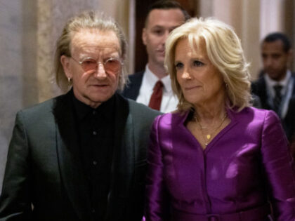 WASHINGTON, DC - FEBRUARY 07: Singer-songwriter Bono and U.S. first lady Jill Biden depart