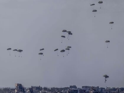 07 March 2024, Israel, Sderot: International air planes, pictured from Sderot, airdrop aid