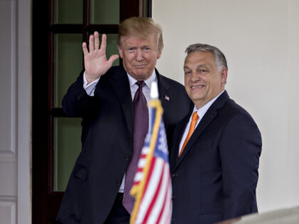 U.S. President Donald Trump, left, waves while standing with Viktor Orban, Hungary's prime