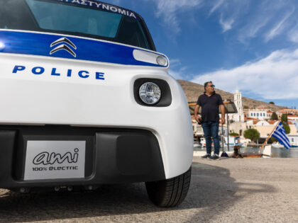 A Citroen Ami compact electric police vehicle at the port on the island of Halki, Greece,