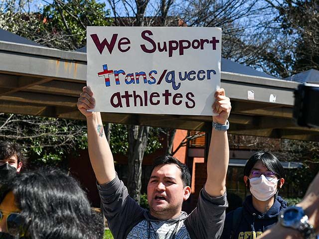 Counter-protestors gather to support transgender swimmer Lia Thomas at the NCAA Swimming a