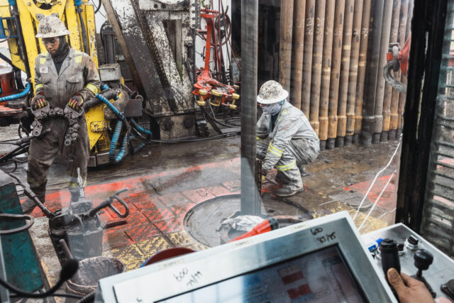 Workers drill for oil on the land that the University of Texas System overseas in Andrews,