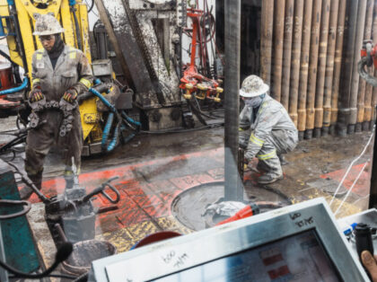 Workers drill for oil on the land that the University of Texas System overseas in Andrews,