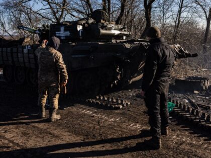 Soldiers from the Ukrainian armed forces' 10th brigade repair a T-72 tank track in th