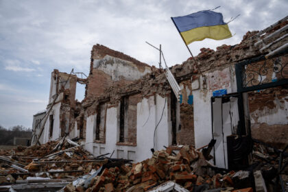LUHANSK OBLAST, UKRAINE - MARCH 15: A Ukrainian flag on the wall of the destroyed school w