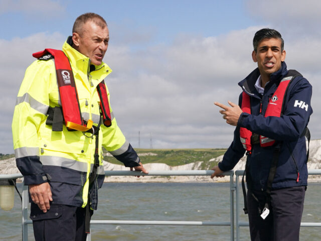 Britain's Prime Minister Rishi Sunak talks with director of Small Boats Operational Comman
