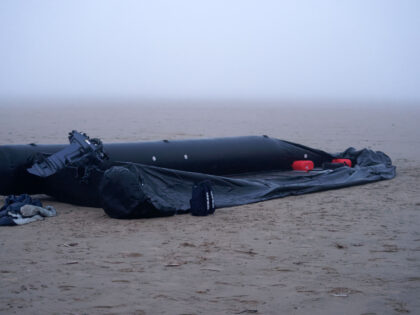 GRAVELINES, FRANCE - JANUARY 13: A burst inflatable boat on the sand in the early morning,