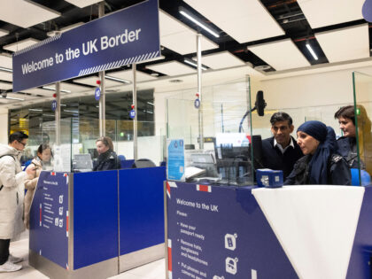 LONDON, ENGLAND - JANUARY 18: UK Prime Minister Rishi Sunak looks at the passport control