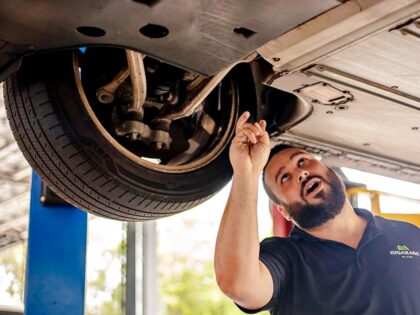 Jonathan Sanchez, the tech lead and shop supervisor at EV Garage Miami, examines a tire of