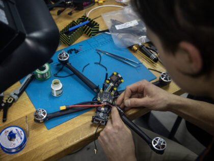 LVIV, UKRAINE - FEBRUARY 26: An employee of HentaiFPV Drones builds a new FPV drone for mi
