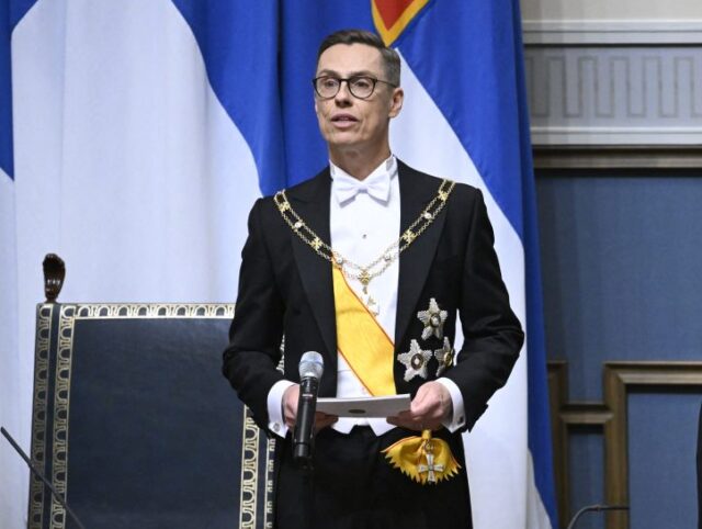 Outgoing President of the Republic of Finland Sauli Niinistö (R) listens as President-ele