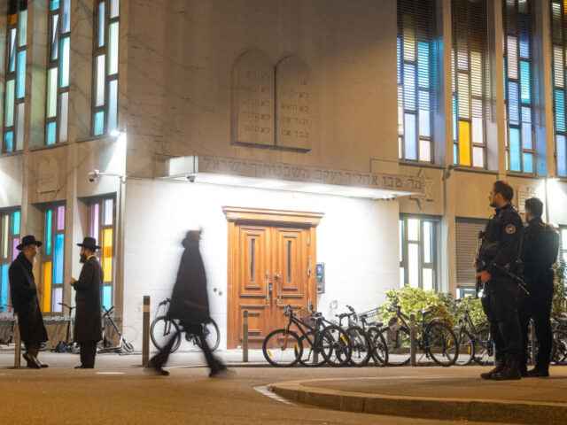 Police officers stand guard at the Synagoge Agudas Achim in Zurich, on March 3, 2024, afte