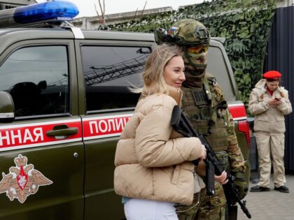 ROSTOV-ON-DON, RUSSIA - MARCH 3: A woman poses for a photo with a soldier as the train, na