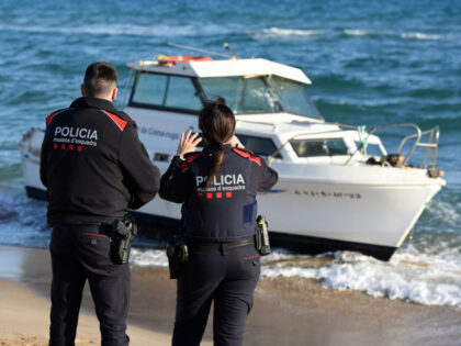 VENDRELL, TARRAGONA, SPAIN - 2024/03/06: Two agents of the Catalan Police guard a boat fro