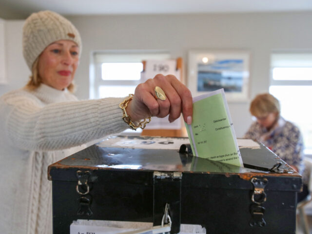 An Islander, Maria McSweeney casts her ballot inside the polling station set up in the liv